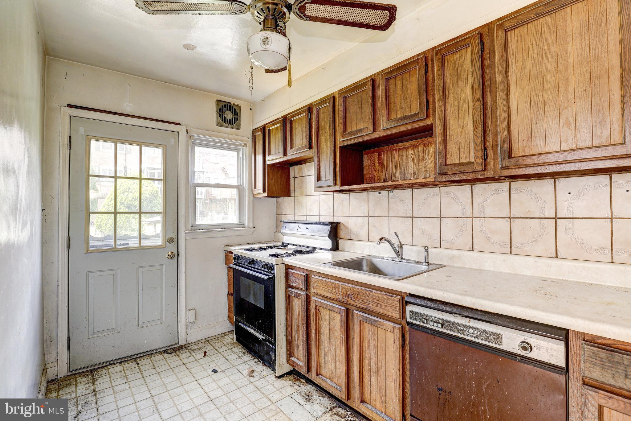 8656 Rock Oak Road Baltimore, MD 21234 - Photo 12 of 22 a kitchen with stainless steel appliances granite countertop a sink a stove cabinets and a window
