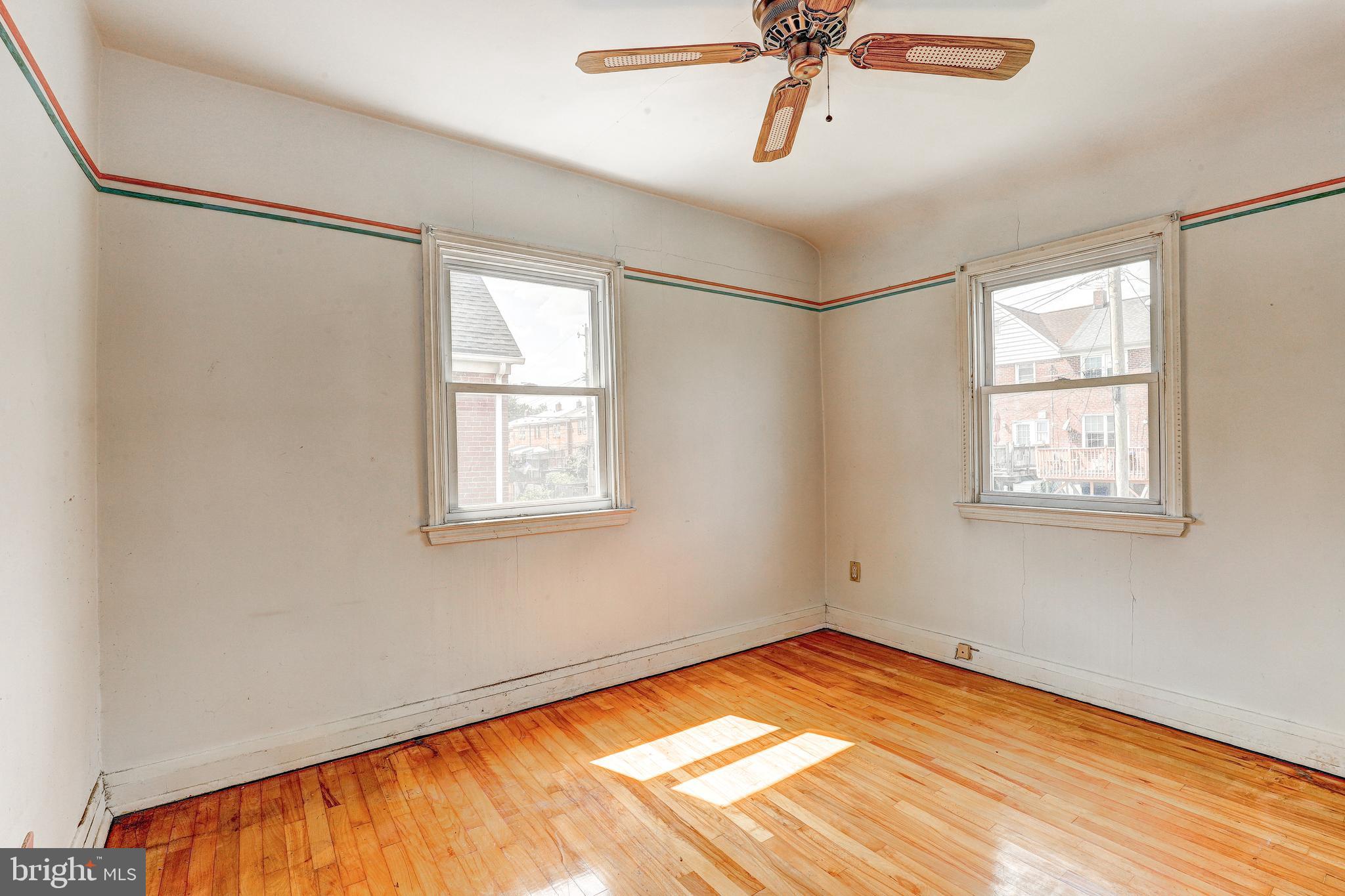 8656 Rock Oak Road Baltimore, MD 21234 - Photo 16 of 22 a view of a room with a window and wooden floor