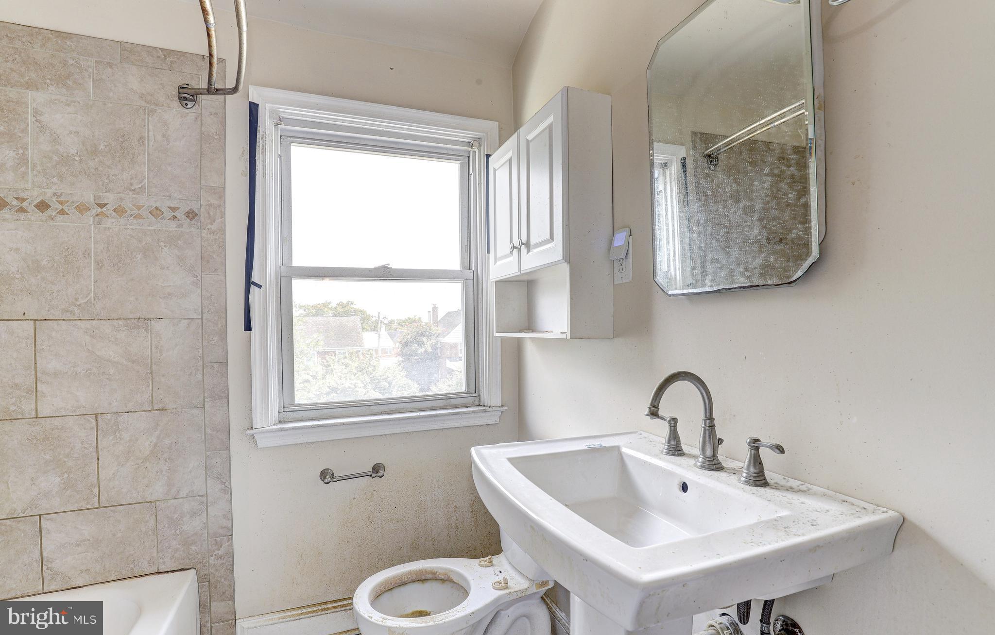 8656 Rock Oak Road Baltimore, MD 21234 - Photo 19 of 22 a bathroom with a sink and a toilet