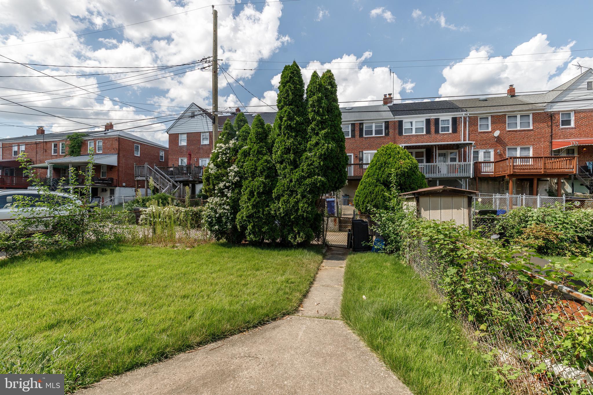 8656 Rock Oak Road Baltimore, MD 21234 - Photo 20 of 22 a view of a house next to a big yard and large trees