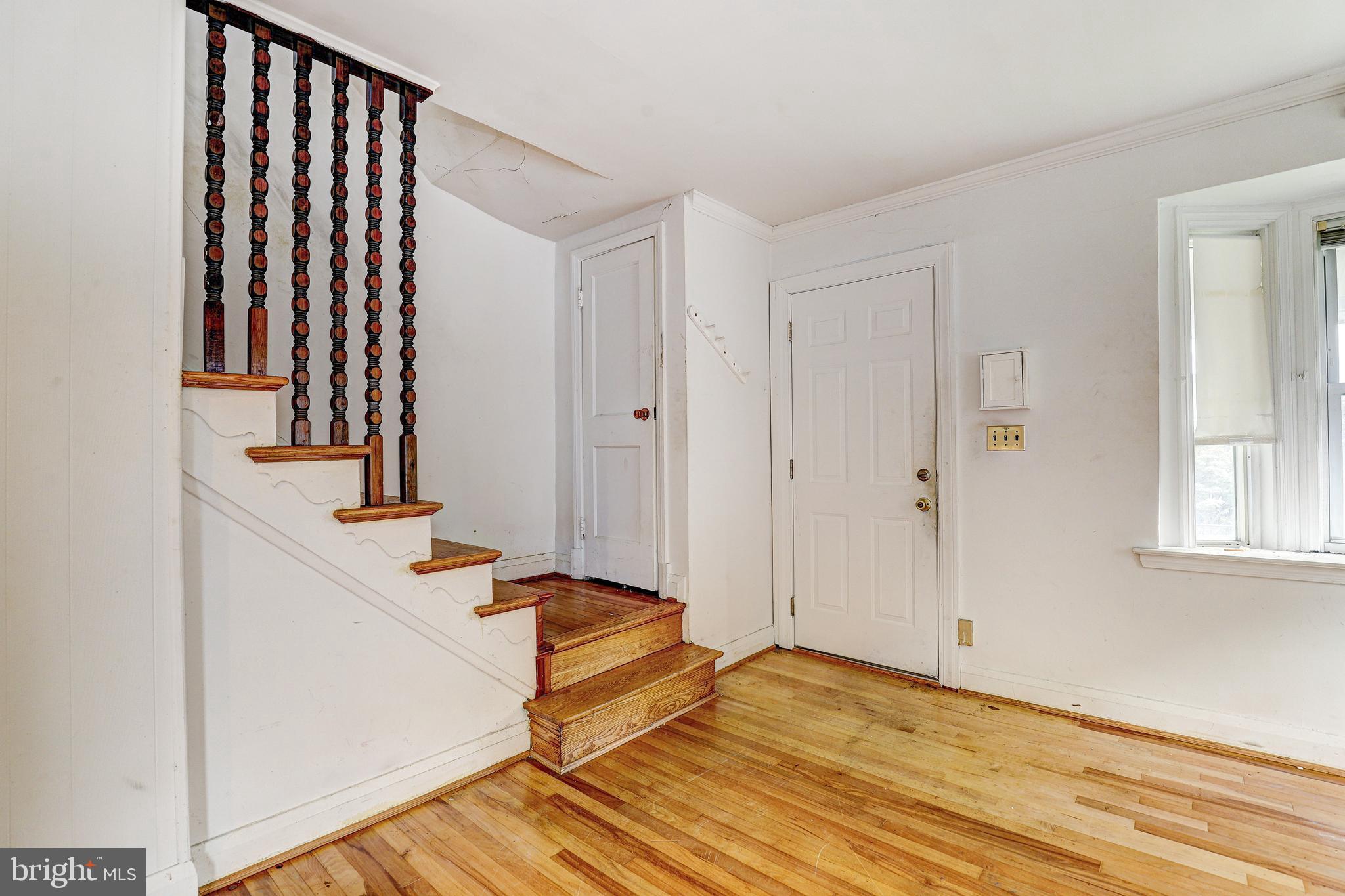 8656 Rock Oak Road Baltimore, MD 21234 - Photo 3 of 22 a view of a room with wooden floor and staircase