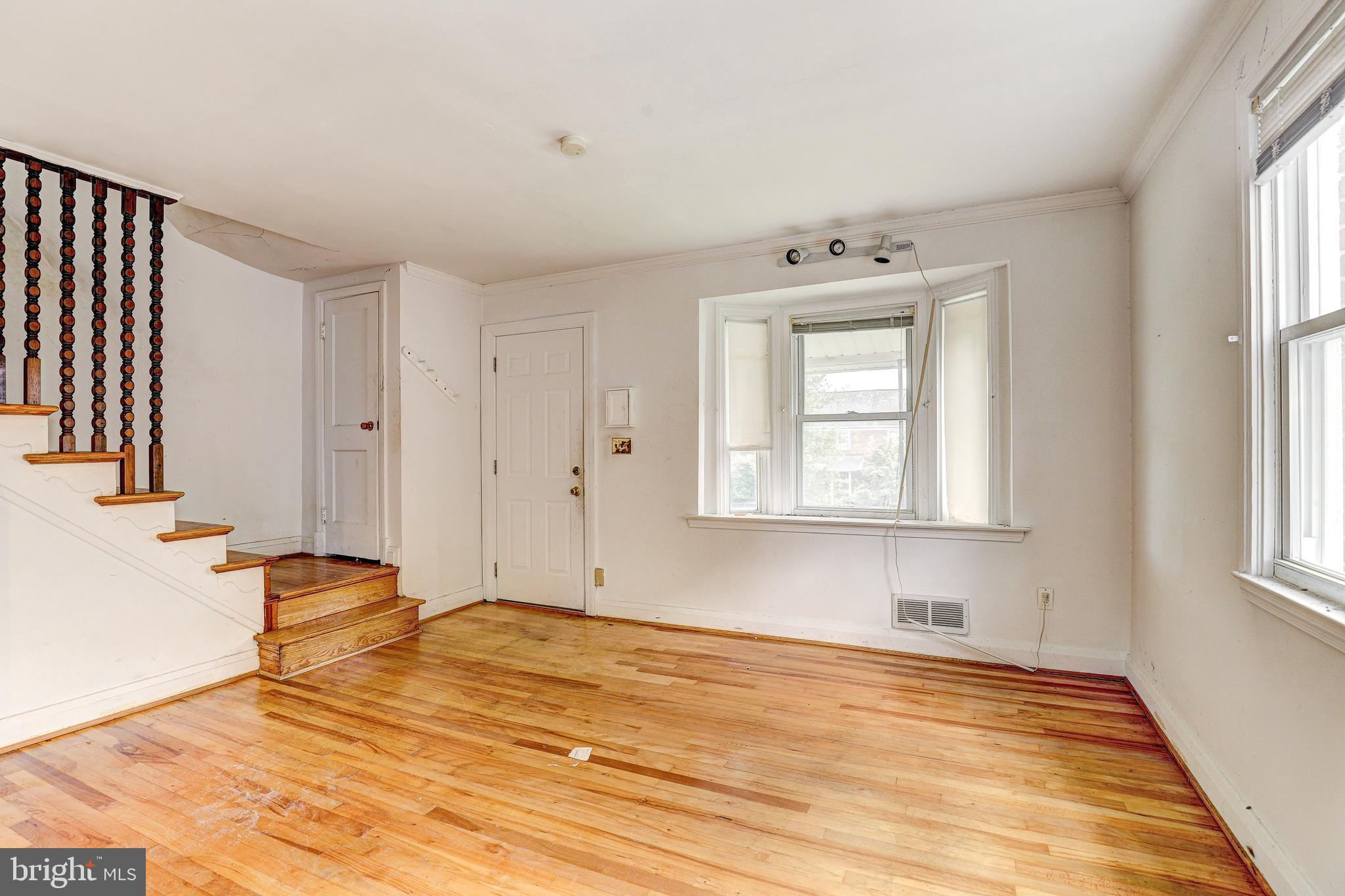 8656 Rock Oak Road Baltimore, MD 21234 - Photo 4 of 22 a view of empty room with wooden floor and fan
