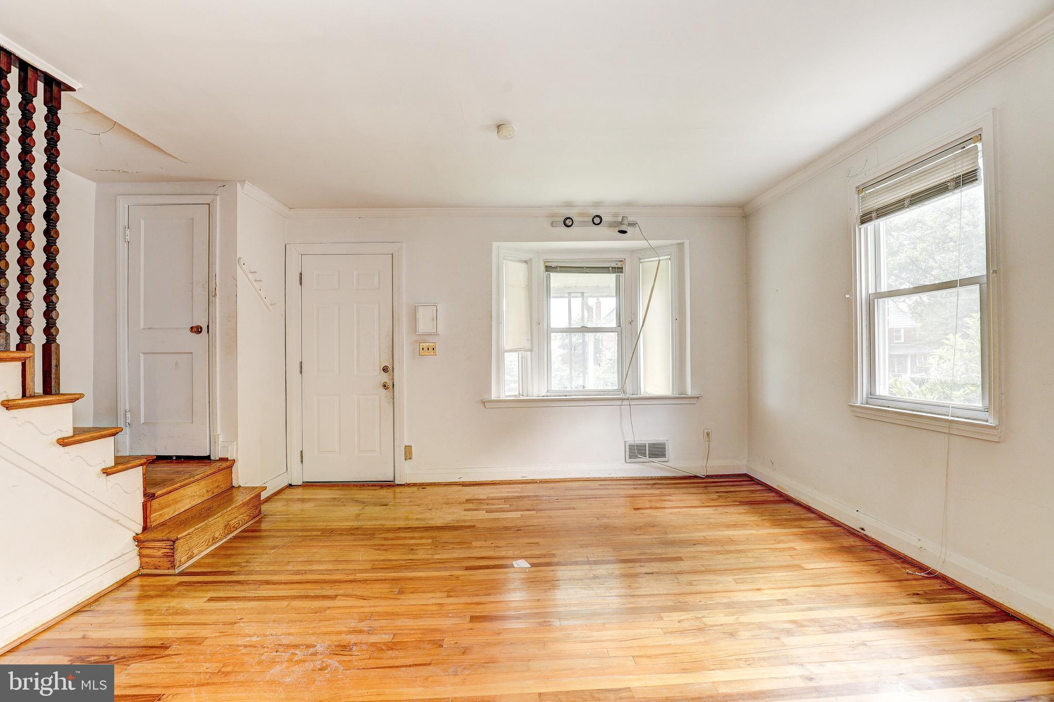 8656 Rock Oak Road Baltimore, MD 21234 - Photo 5 of 22 a view of empty room with wooden floor and fan