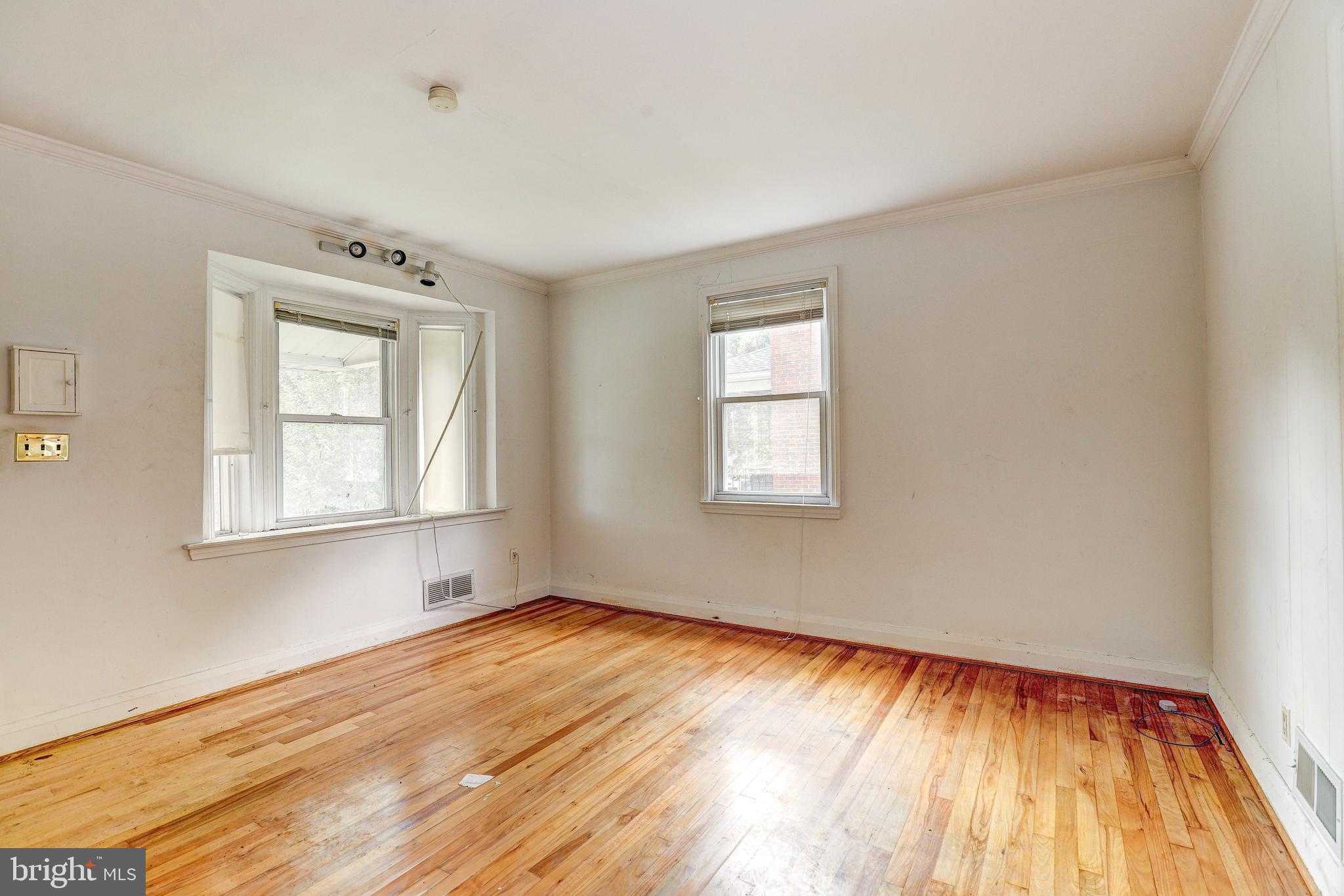 8656 Rock Oak Road Baltimore, MD 21234 - Photo 6 of 22 a view of an empty room with wooden floor and a window