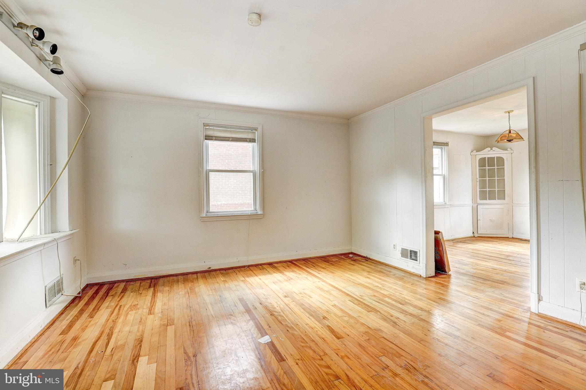 8656 Rock Oak Road Baltimore, MD 21234 - Photo 7 of 22 an empty room with wooden floor and windows