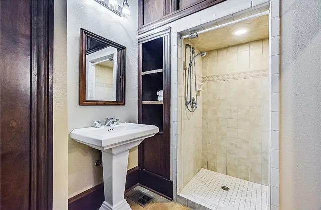 a bathroom with a sink a mirror and a shower