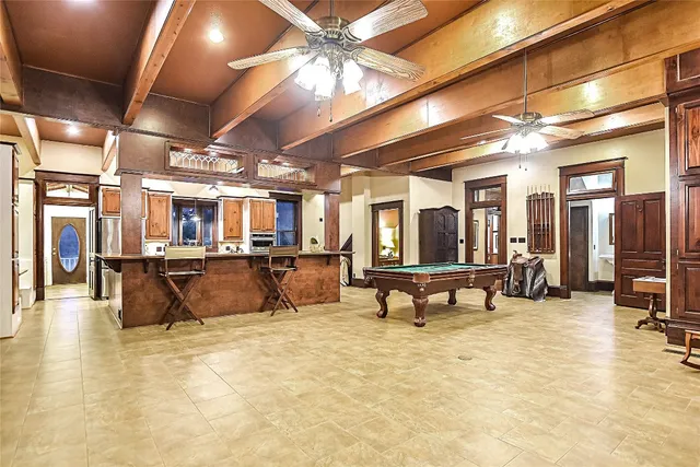 a living room with fireplace furniture and a book shelf
