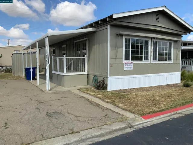a view of a house with wooden fence