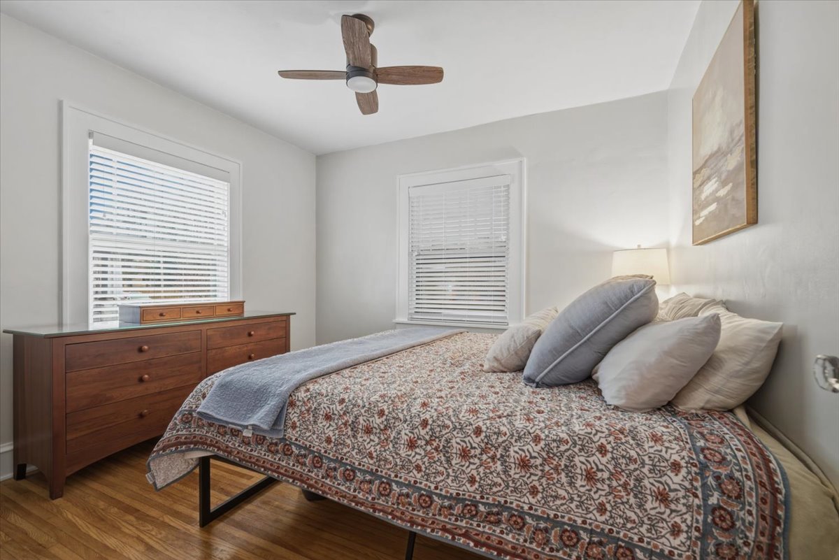 611 Vale Street Bloomington, IL 61701 - Photo 12 of 36 a bedroom with a large bed and two large window
