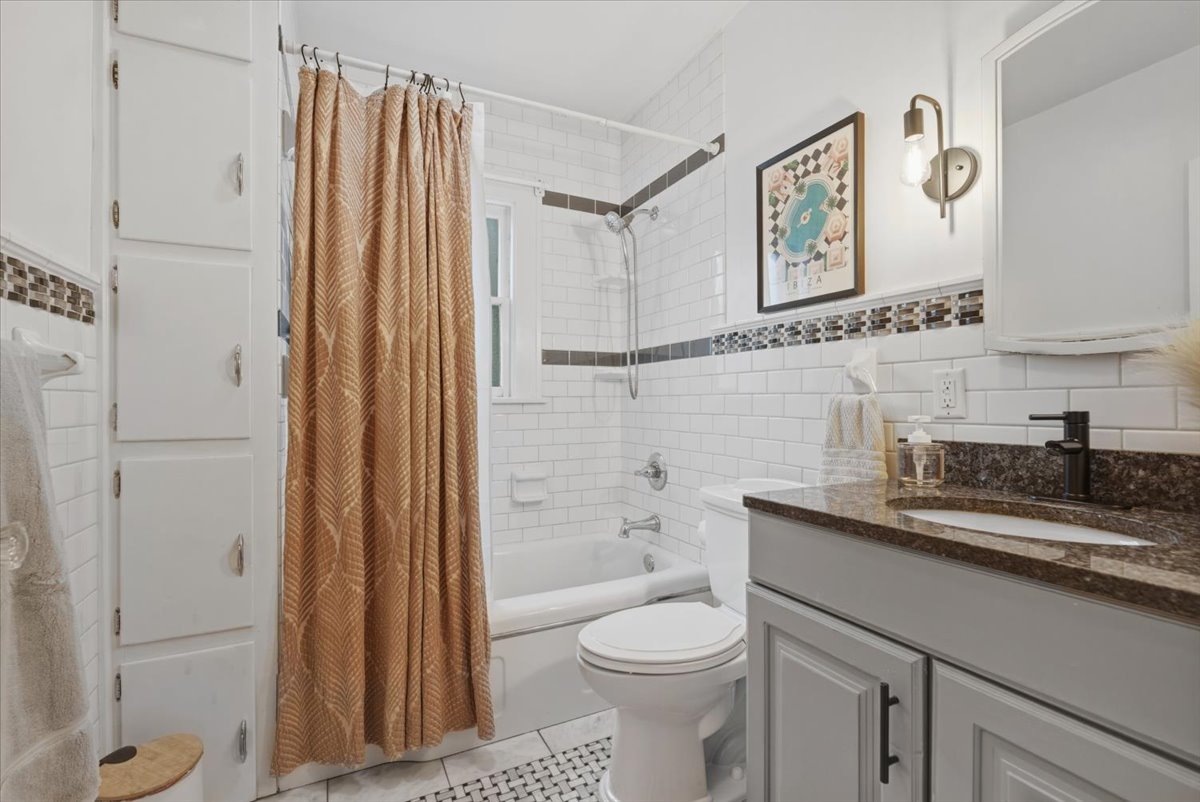 611 Vale Street Bloomington, IL 61701 - Photo 13 of 36 a bathroom with a granite countertop sink toilet and shower