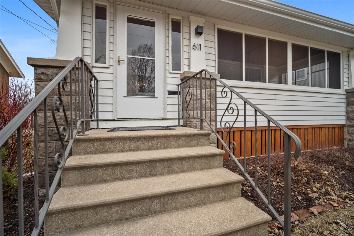611 Vale Street Bloomington, IL 61701 - Photo 2 of 36 a view of staircase with railing and a large window
