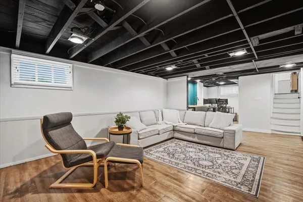 a living room with a couch wooden floor and a table