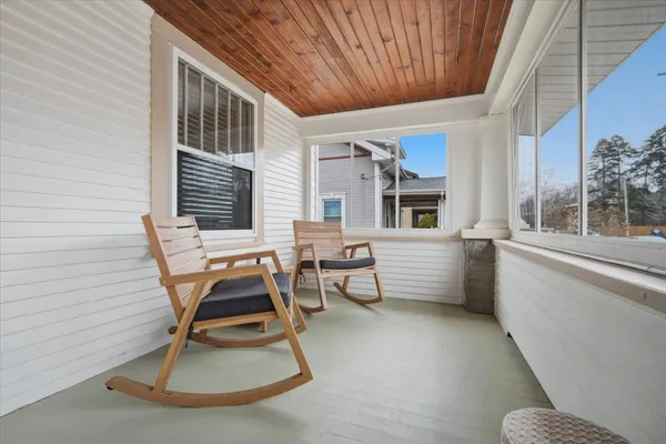 a view of a chairs and table in a balcony