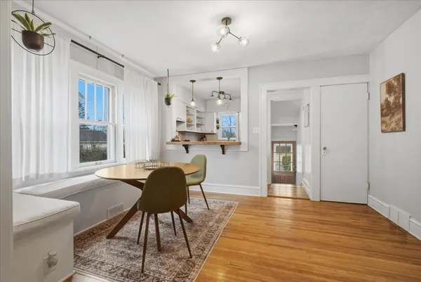 a view of a dining room with furniture window and wooden floor