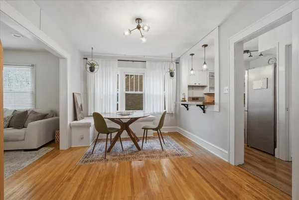 a dining room with furniture and wooden floor