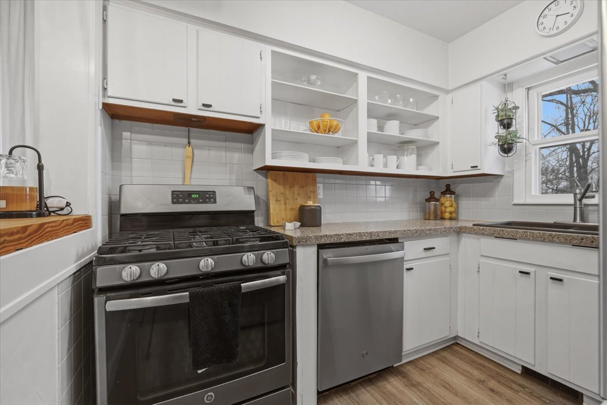 611 Vale Street Bloomington, IL 61701 - Photo 10 of 36 a kitchen with granite countertop cabinets stainless steel appliances and wooden floor