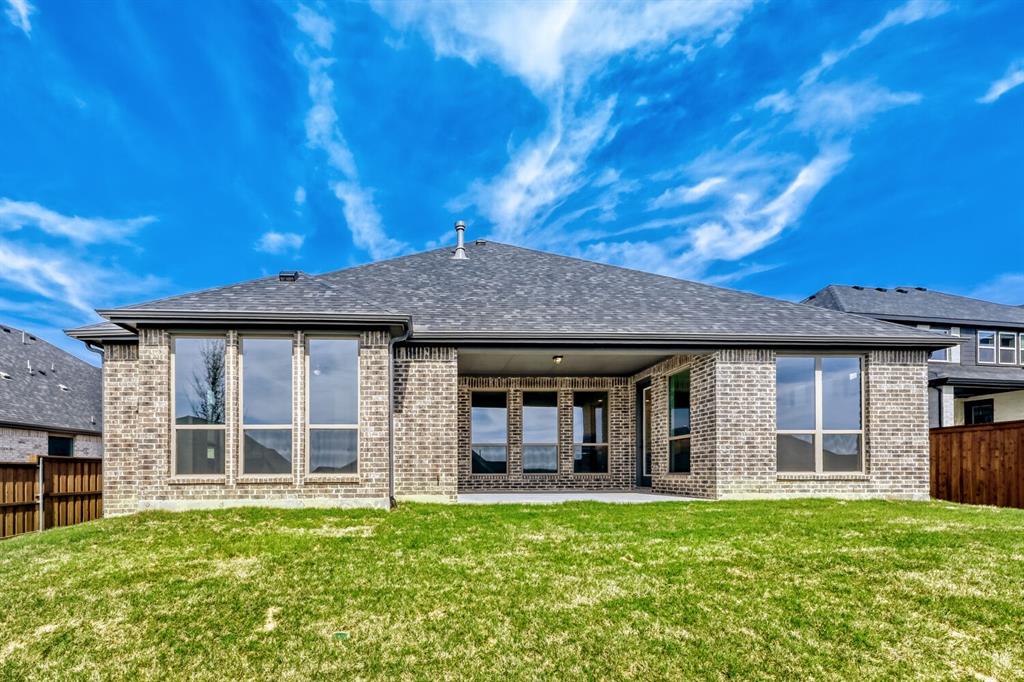147 Derrett Lane Rhome, TX 76078 - Photo 24 of 28 Rear view of house featuring a fenced backyard, brick siding, and a patio area