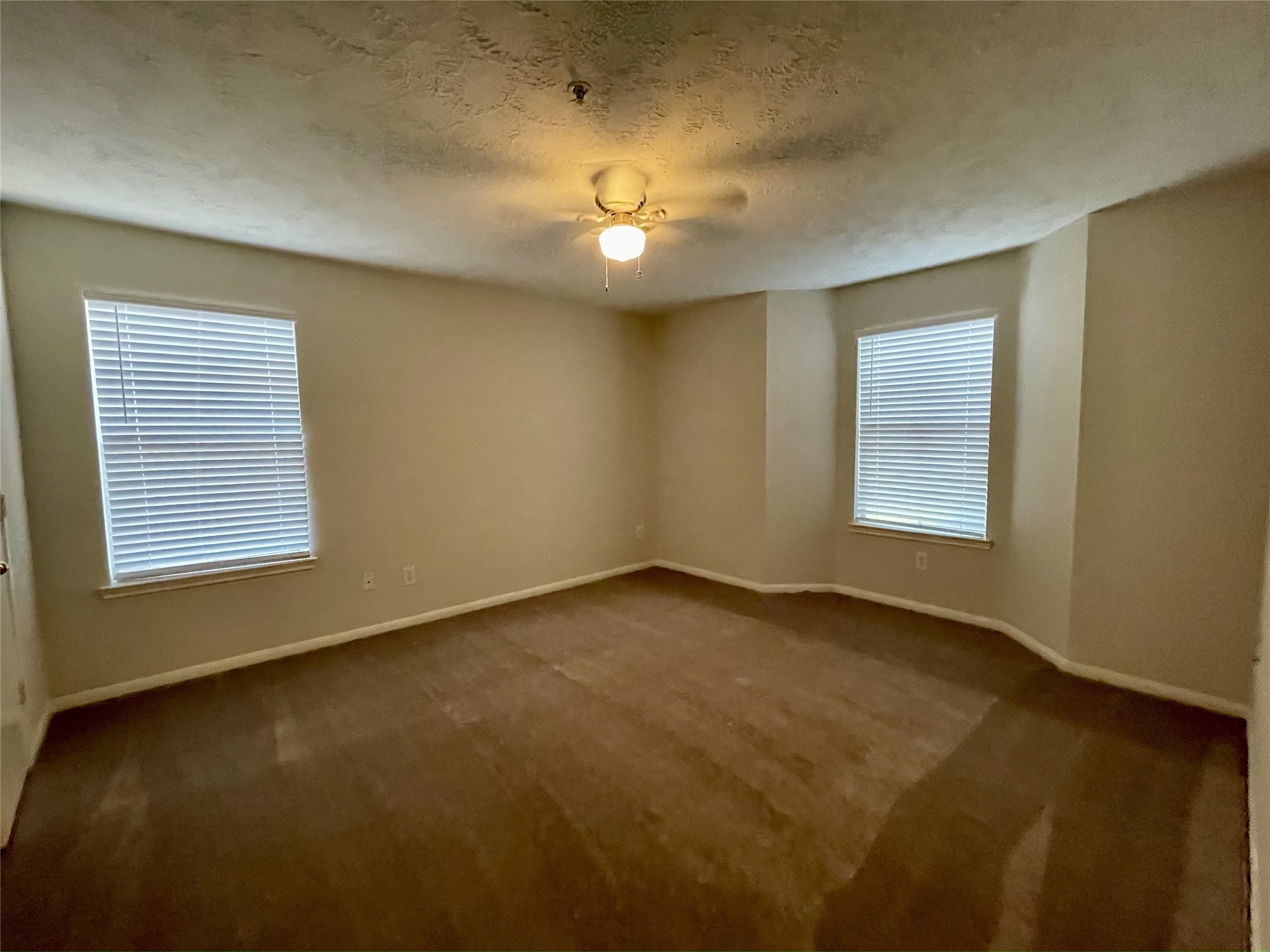 8051 Bay Branch Drive, Unit 312 The Woodlands, TX 77382 - Photo 13 of 22 an empty room with a ceiling fan and window
