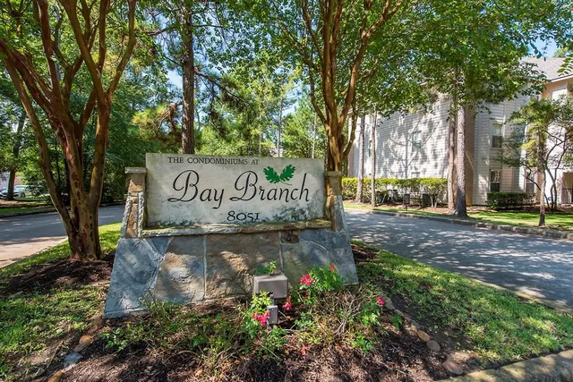 a view of outdoor space with sign board and garden