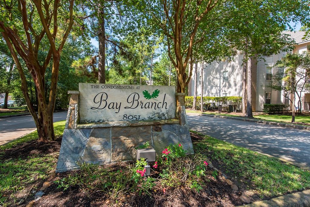 8051 Bay Branch Drive, Unit 312 The Woodlands, TX 77382 - Photo 18 of 22 a view of outdoor space with sign board and garden