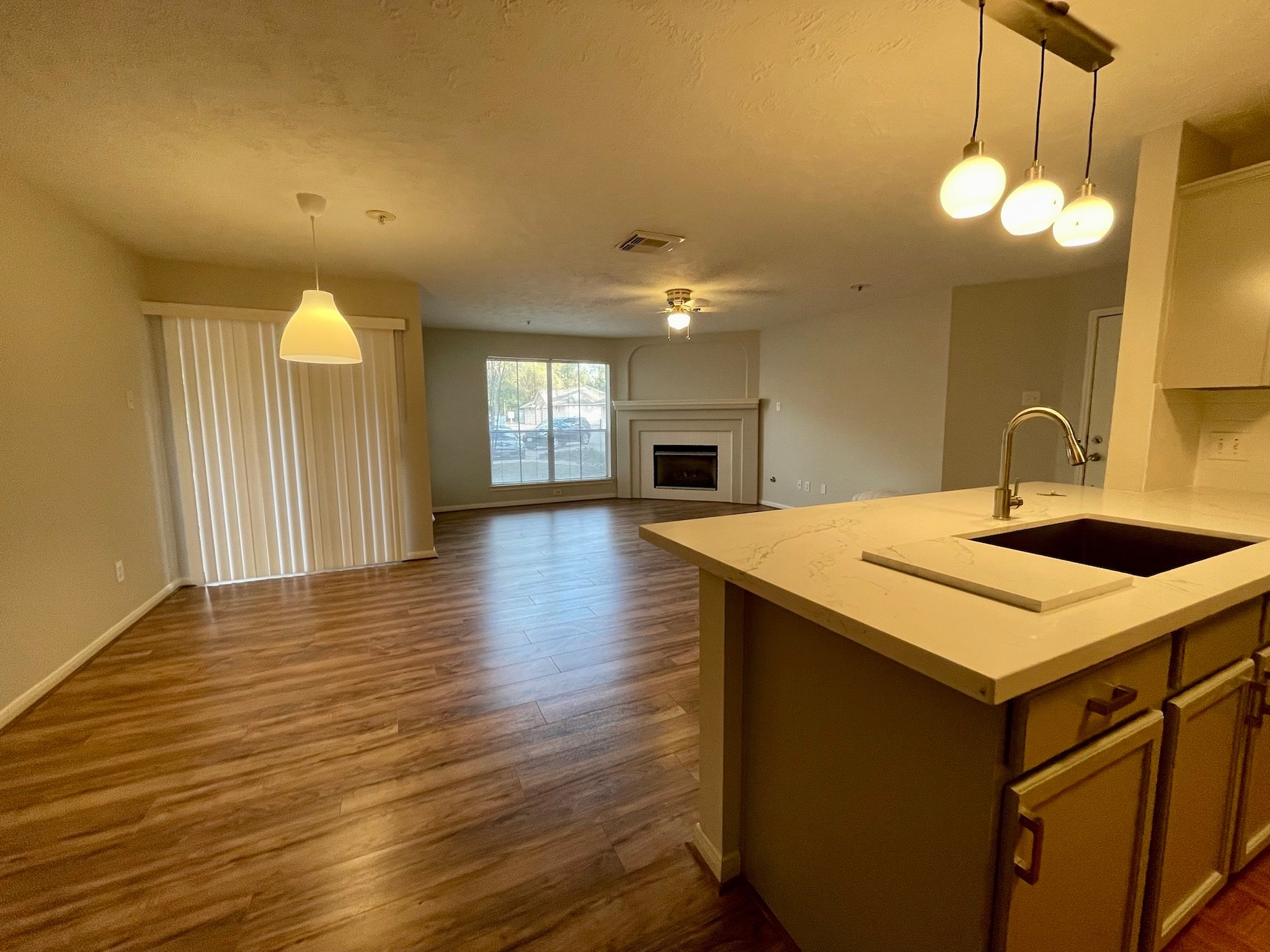 8051 Bay Branch Drive, Unit 312 The Woodlands, TX 77382 - Photo 2 of 22 a kitchen with a sink and chandelier