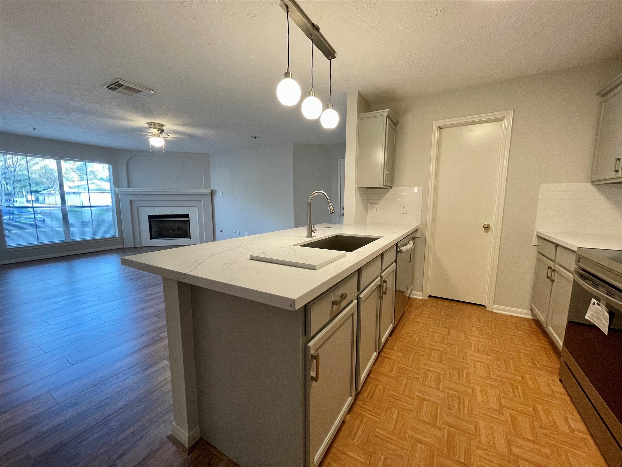 8051 Bay Branch Drive, Unit 312 The Woodlands, TX 77382 - Photo 9 of 22 a kitchen with a sink and a stove top oven