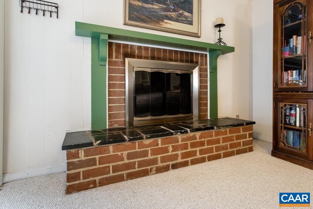 2938 Milton Road Charlottesville, VA 22902 - Photo 17 of 44 a living room with fireplace furniture and a book shelf