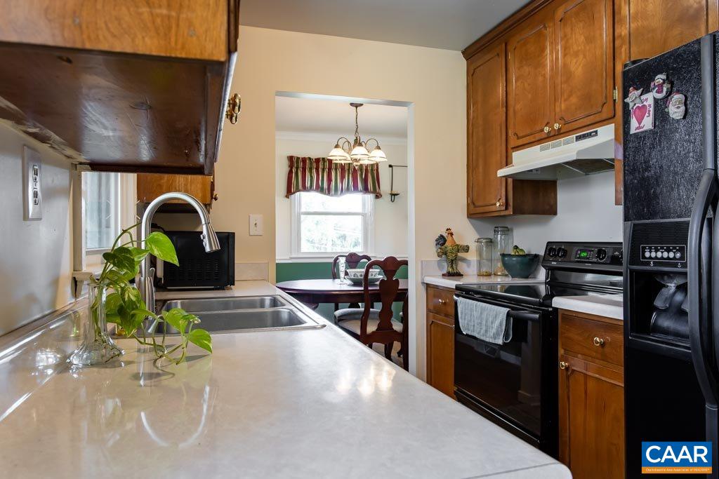 2938 Milton Road Charlottesville, VA 22902 - Photo 7 of 44 a kitchen with granite countertop a stove a sink and a dining table