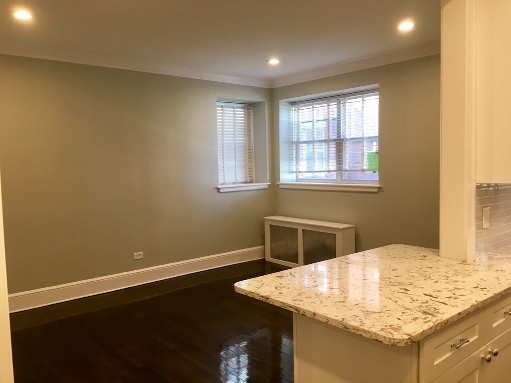 1834 Beacon Street, Unit 3 Brookline, MA 02445 - Photo 3 of 7 a view of kitchen island with wooden floor