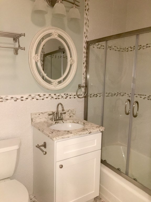 1834 Beacon Street, Unit 3 Brookline, MA 02445 - Photo 6 of 7 a bathroom with a sink a toilet and shower