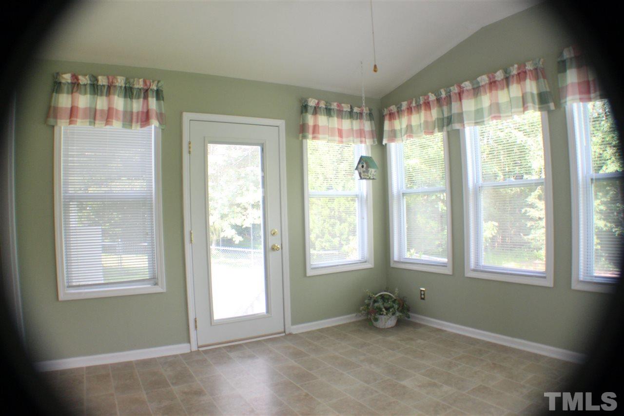 4112 Mebane Oaks Road Mebane, NC 27302 - Photo 8 of 22 Serene, relaxing is the feeling you get in the sun room overlooking the backyard with a door to deck and to back yard.