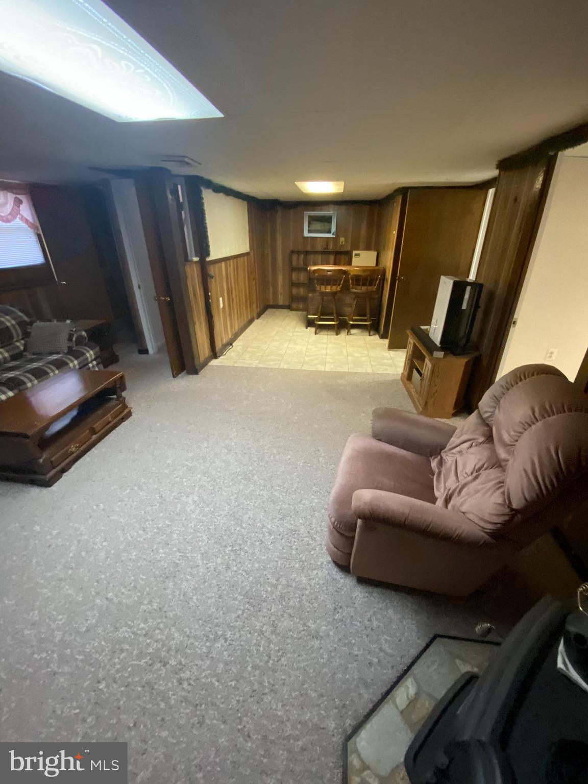 1907 Monumental Road Baltimore, MD 21227 - Photo 19 of 37 a living room with furniture and a flat screen tv