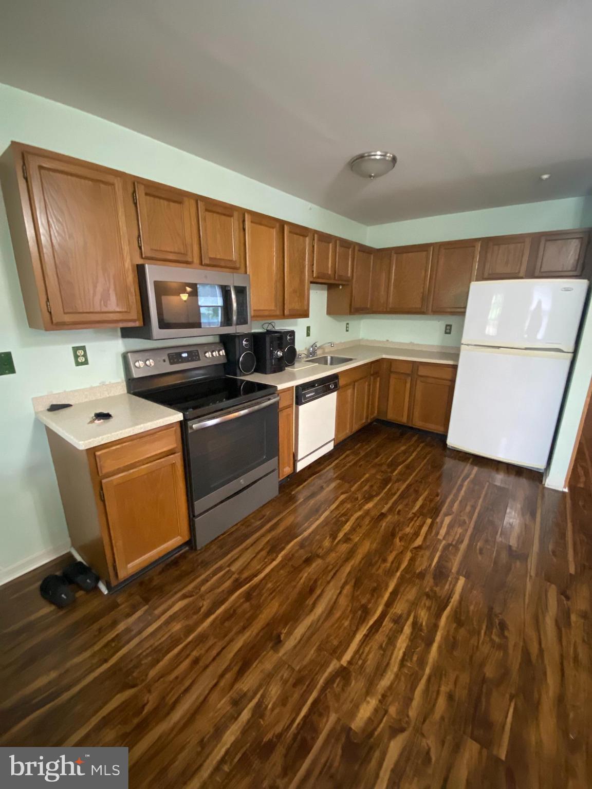 1907 Monumental Road Baltimore, MD 21227 - Photo 3 of 37 a kitchen with a sink a stove top oven a counter space and cabinets