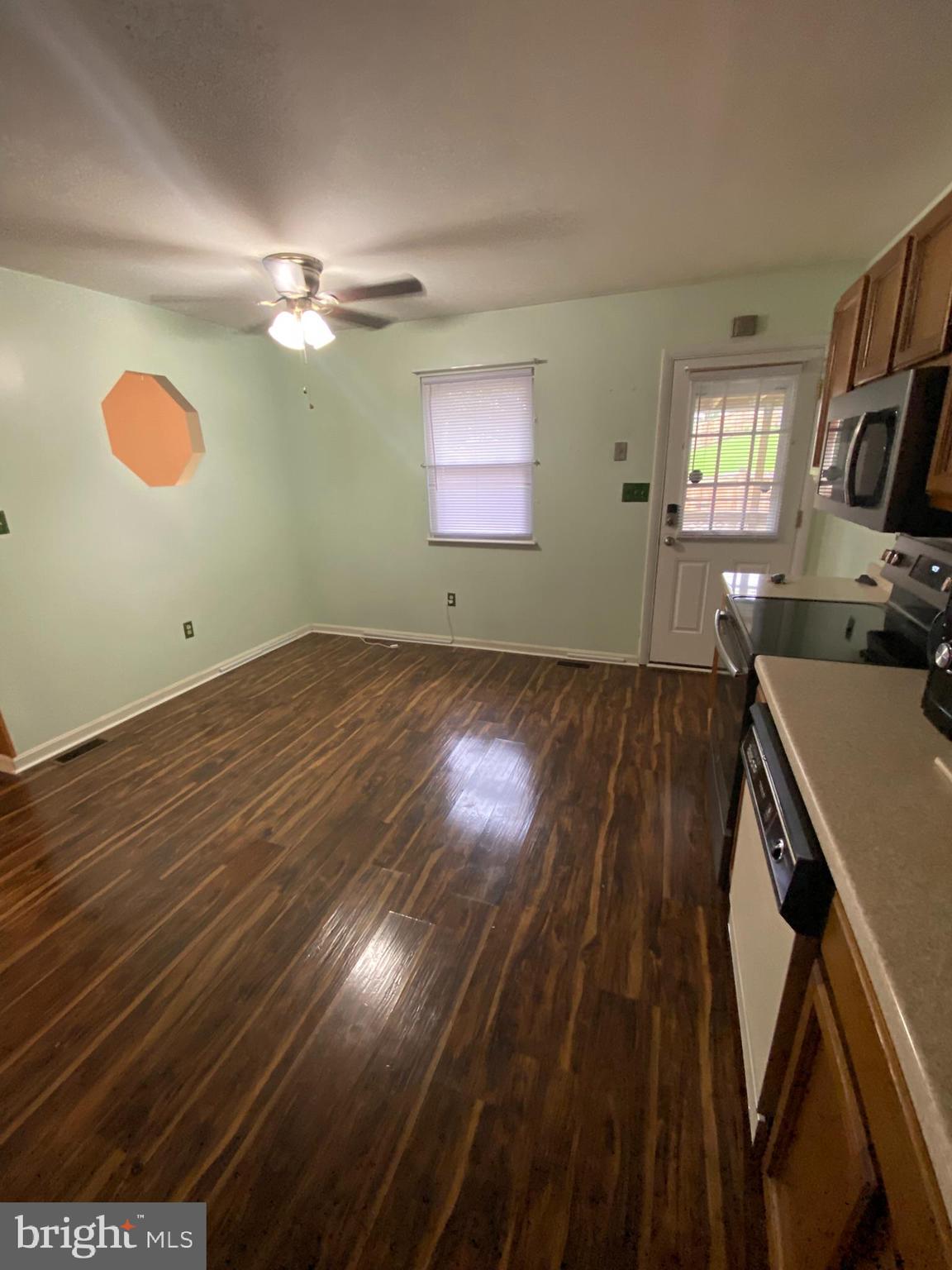 1907 Monumental Road Baltimore, MD 21227 - Photo 4 of 37 a view of a livingroom with hardwood floor and a ceiling fan