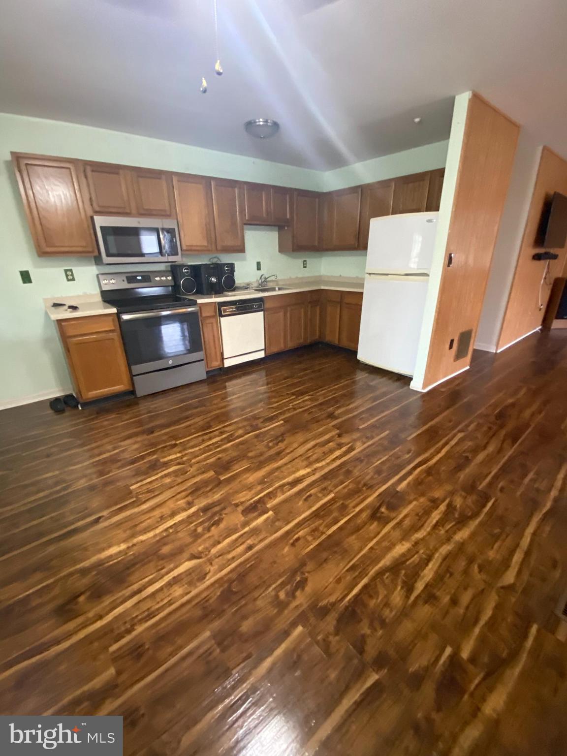 1907 Monumental Road Baltimore, MD 21227 - Photo 6 of 37 a kitchen with stainless steel appliances wooden cabinets and a counter top space