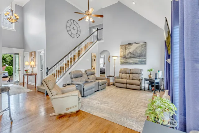a kitchen with kitchen island granite countertop white cabinets white stainless steel appliances with a sink and dishwasher