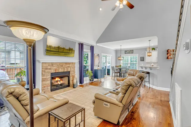a large kitchen with a lot of counter space and wooden floor