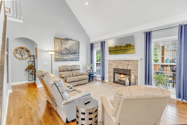 a kitchen with stainless steel appliances granite countertop a sink dishwasher a refrigerator and a stove with wooden floor