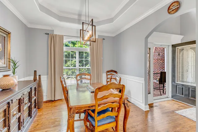 a kitchen that has a lot of cabinets in it and wooden floor