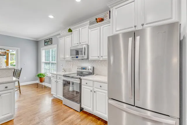 a view of a dining room with furniture and wooden floor