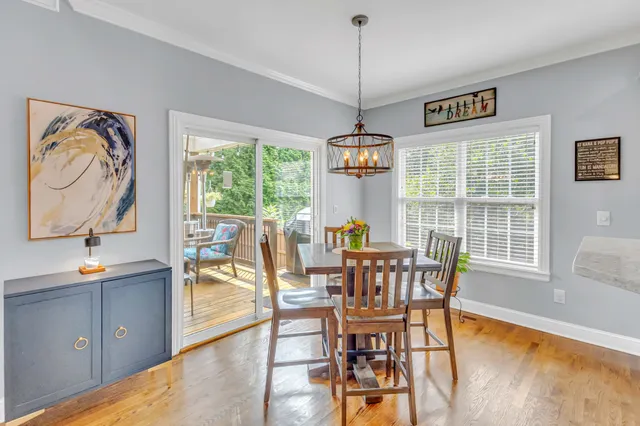 a spacious bathroom with a granite countertop sink a mirror a vanity and a bathtub