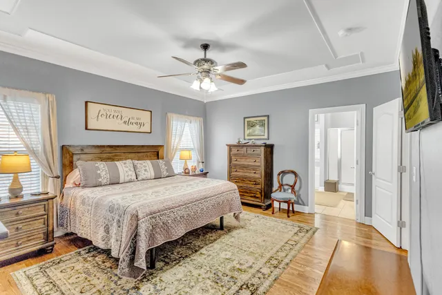 a bedroom with furniture and a large window