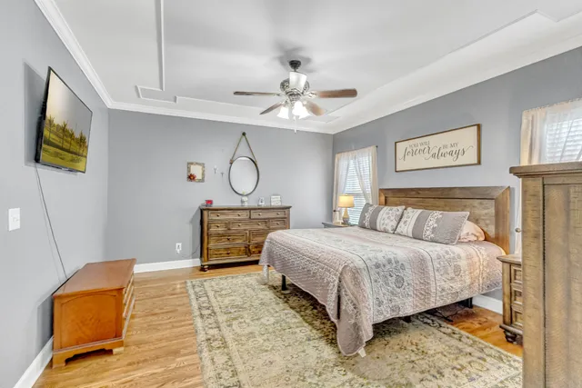 a bedroom with a bed and a ceiling fan