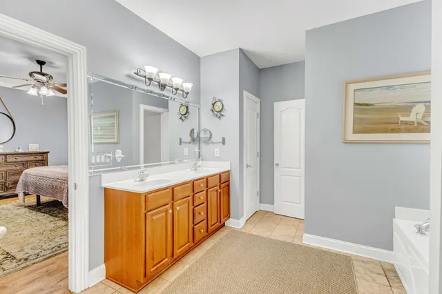 a bedroom with a bed and ceiling fan