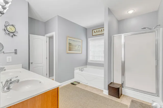 a bathroom with a granite countertop sink a mirror and a shower