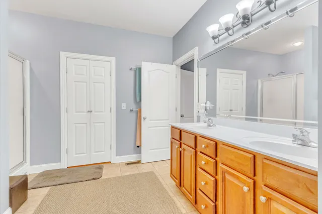 a bathroom with a double vanity sink and a mirror