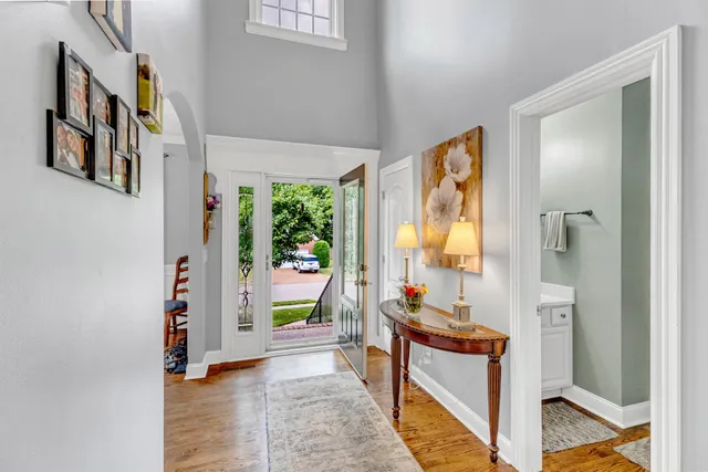 a living room with furniture dining table and a chandelier