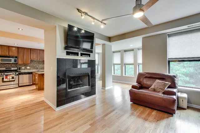 a living room with furniture fireplace and flat screen tv