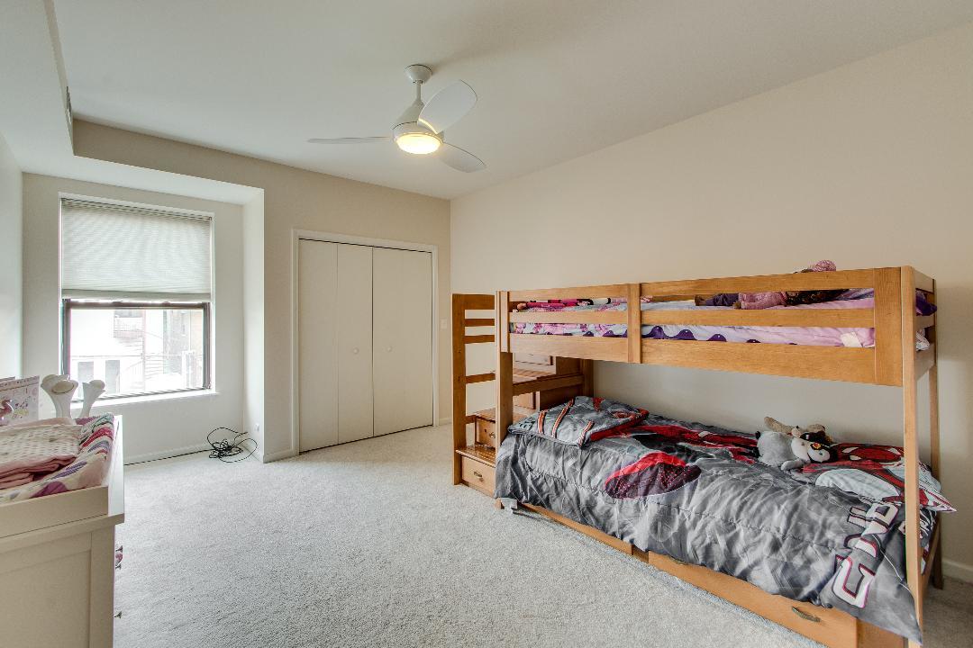 4740 South Ingleside Avenue, Unit 2N Chicago, IL 60615 - Photo 8 of 12 a bed room with a bed and a window