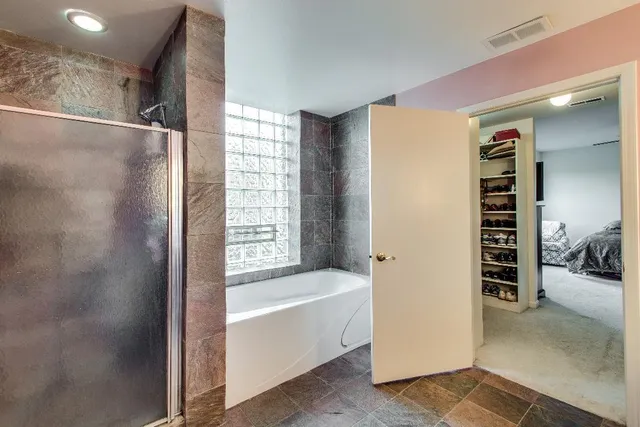 a bathroom with a bathtub and a shower